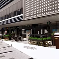 Modern Commercial Street With Stylish Storefronts Pedestrian Walkway And Outdoor Decorative Plants