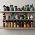 Various Glass Spice Jars Arranged On Kitchen Wooden Shelves For Organized Storage
