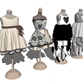 Mannequins Displaying Various Style Dresses With Bow Heart Pattern And Layered Skirts