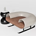 Modern Curved Single Seater Sofa With Beige Armrests Brown Cushion Metal Base And Decorative Side Table