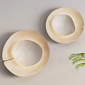 Sleek Two Beige Wall Lamps Mounted on Light Colored Wall With Green Plant and Vase