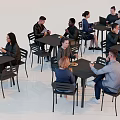 Group of People Sitting at Tables in Modern Café Enjoying Meals and Conversations Together