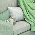 Modern Green Sectional Sofa With Decorative Pillows And Throw Blanket 3d model