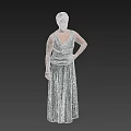 Elegant Woman in Green Long Dress Posing with Hand on Hip Against Neutral Gray Backdrop