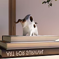 White Bull Sculpture with Brown Horns and Spots on Stacked Books for Indoor