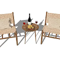 Wicker and Wooden Table and Chair Set With Wine Bottle Glasses And Fruit Plate
