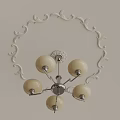 Elegant Ceiling Light Plate with Carved Decoration and Five Off White Spherical Lampshades on White Wall
