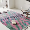 Leisure Chair On Colorful Patterned Rug With Tassels And Stack Of Books In Bright Interior