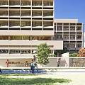 Modern Multi Storey School Building With Large Windows Balconies And Green Lawn Area
