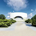 Modern School Building with Circular Design Greenery and Paved Pathway Under Blue Sky