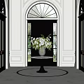 Stylish Entryway With Black Door Marble Vase And White Green Flower Arrangement On Round Table