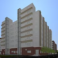 Modern Office Building Exterior With Glass Curtain Walls Brick Facade And Roadside Landscaping