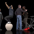Four People Interacting with Bicycle and White Sphere While Standing and Raising Hands