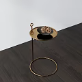Round Coffee Table With Golden Stand Black Tray Pine Cones On Dark Wood Floor White Wall