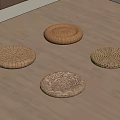 Four Natural Woven Rattan Cushions Arranged On Wooden Floor