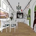 Elegant Bridal Shop With Chandelier White Tables Decorative Paintings Green Arch And Wedding Dresses