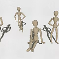 Group of wooden mannequins in various poses including standing and sitting