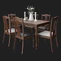 Wooden Dining Table And Chairs Set With Decorative Vase Flowers And Candles On Table
