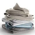 Soft Textured Towels Stacked With Light Gray And Blue Woven Patterns