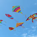 Colorful Kites Flying In Blue Sky With Various Shapes And Designs