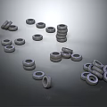 Various Stacked And Scattered Tires In Different Sizes On Gray Background