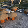 Wooden Dome-Shaped Huts in Stone-Paved Courtyard with Outdoor Hot Spring and Sunshades