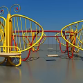Butterfly Shaped Rotating Play Seats With Yellow Red Frames And Wooden Platforms In Garden Landscape