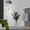 The North Face Clothing Store with Hanging Apparel Poster Display and Green Plants