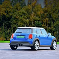 Blue Mini Cooper Car Parked On Paved Road Surrounded By Green Trees 3d model