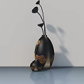 Modern Black Vase With Golden Leaf Patterns And Floral Stems On Smooth Tabletop
