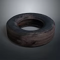 Used Car Tire With Worn Tread And Dark Surface On Gray Background