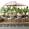 Outdoor Table with Umbrella and Chairs Surrounded by Green Plants on Wooden Deck