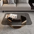 Elegant Modern Coffee Table With Glass Top Bronze Frame And Open Magazines In Living Room
