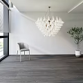 White Petal Chandelier In Modern Interior With Gray Chair Green Plant And Dark Wood Floor
