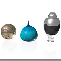 Decorative Golden Patterned Ball Blue Striped Onion Shaped Object And Silver Black Jar Arrangement