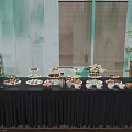 Coffee Break Area Featuring Black Tablecloth Tiered Dessert Stands Fresh Fruits And Beverages