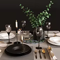 Tableware Set with Black White Plates Wine Glasses Golden Cutlery Green Plant and Candles