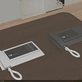 Two Light And Dark Gray Landline Telephones On Wooden Table With White Curly Cords