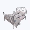 Double Bed With Wrought Iron Frame Ornate Headboard Floral Pillows And Gray Throw Blanket