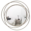 Circular Decorative Mirror With Multiple Metallic Rings Reflecting Bedroom Scene Including Bed Table And Vase