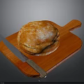 Golden Freshly Baked Artisan Bread On Wooden Cutting Board With Knife