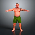 Shirtless Bald Man With Tattoos Wearing Green Shorts Standing With Arms Outstretched Against Gray Background