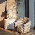 Striped Accent Leisure Chair With White Nightstand Table Lamp Floral Painting And Sunlight Shadows
