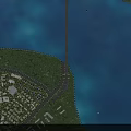 Aerial Planning of Coastal Area With Bridge Residential Community and Green Spaces
