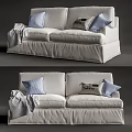 White Two Seater Sofa Featuring Plaid And Decorative Pillows With Folded Blanket