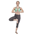Woman Practicing Yoga Tree Pose Standing On One Leg With Hands In Prayer