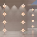 Modern Star Shaped Chandeliers Hanging In Minimalist Indoor Space With Soft Lighting