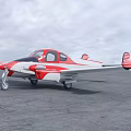 Red and White Twin Engine Passenger Plane Parked on Gray Tarmac