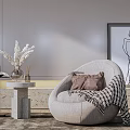 Curved Beige Single Sofa with Brown Pillows Striped Throw Blanket Stone Table and Minimalist Painting