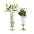 Two Decorative Transparent Glass Vases with White Flowers Green Leaves and Gold Bases